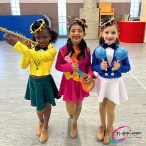 three young dancers posing for a picture